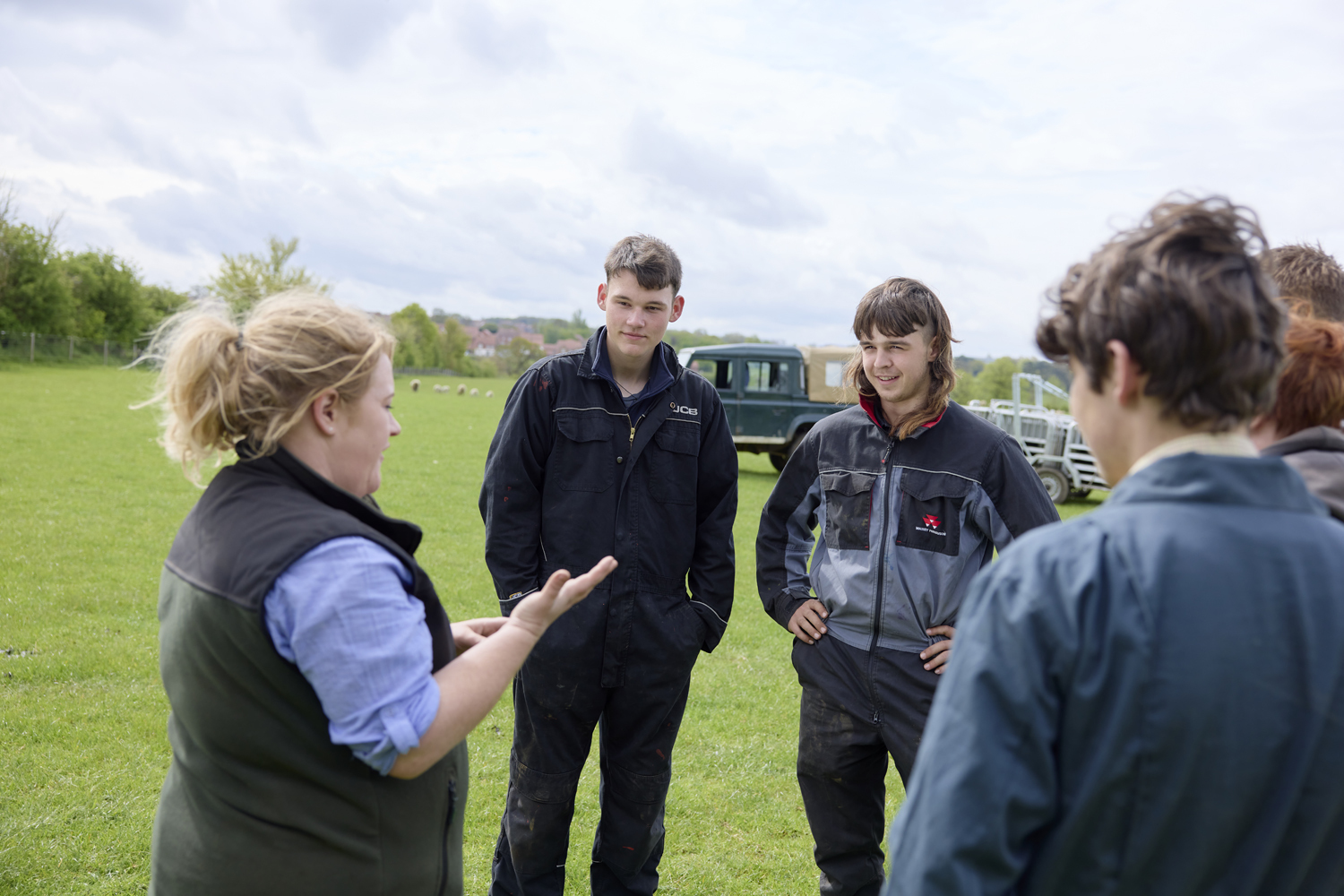 Agriculture lecturer and students in field