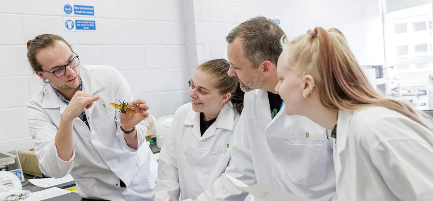 Lecturer and students in animal science lab