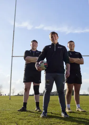 Rugby Academy boys team in front of post