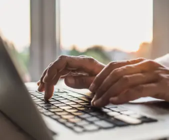 Person typing on laptop